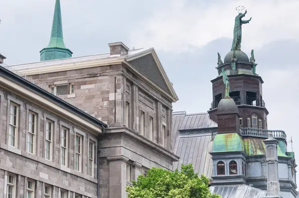 stock image the facade and statues on top of Notre Dame de BonSecours Chapel and market in montreal Canada on an overcast day.