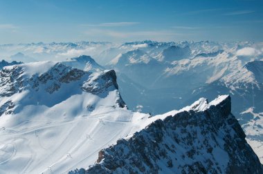 A panoramic view of the snow capped Wetterstein mountains from on top zugspitze in Garmisch-Partenkirchen Germany. clipart