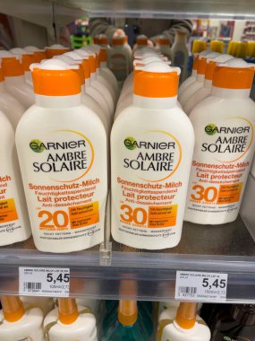 Berlin, Almanya - 27 Aralık 2021: Garnier Ambre Solaire güneş kremi şişeleri. Garnier, Fransız kozmetik şirketi L 'Oral' ın bir kitle pazarı kozmetik markası. Saç bakımı ve cilt bakım ürünleri üretiyor.