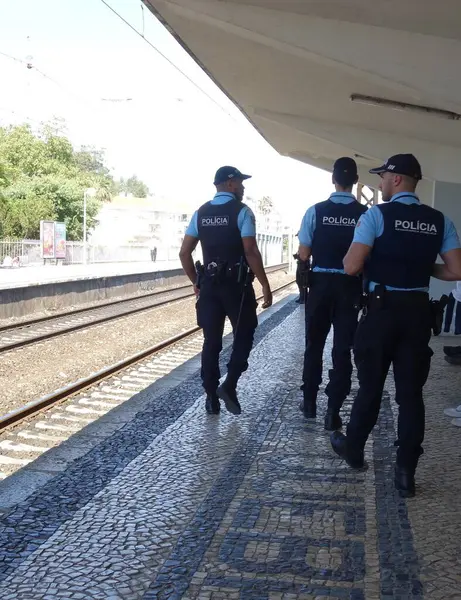 stock image Lisbon, Portugal - May 26, 2024: Portuguese policemen on patrol along a railway platform