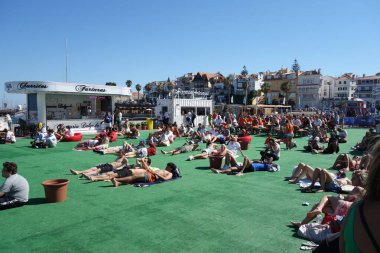 Cascais, Portugal - July 2, 2024: People watching the Netherlands vs. Romania Uefa European Championship game in the Euro Park fan zone, Cascais, Portugal clipart