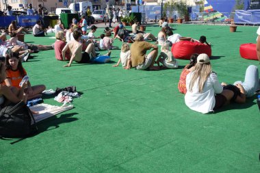 Cascais, Portugal - July 2, 2024: People watching the Netherlands vs. Romania Uefa European Championship game in the Euro Park fan zone, Cascais, Portugal clipart