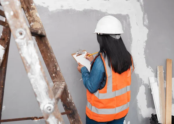 A construction supervisor checks renovation project with checklist on clipboard. High quality photo