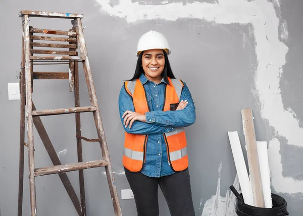 Portrait of a construction worker against cracked and repaired wall smiling. High quality photo