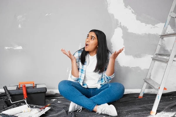 Young Indian woman frustrated, stuck with home DIY project. High quality photo