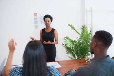 Business leader answers question from attendee at meeting in office. High quality photo