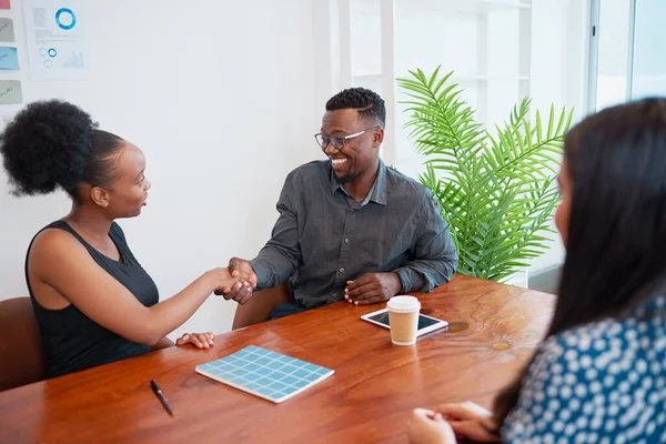 stock image Business colleagues shake hands at boardroom table, making agreement deal. High quality photo