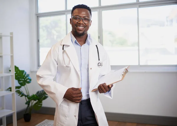 Portrait of a Black doctor holding clipboard with patient information. High quality photo