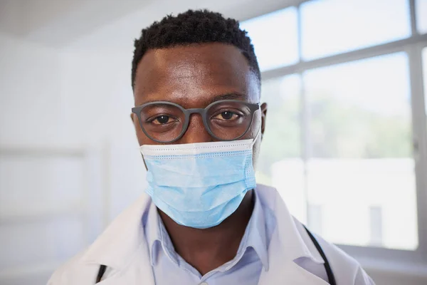 Close up of Black male doctor wearing surgical mask. High quality photo