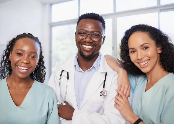 Three medical healthcare professionals stand in a row informal candid pose. High quality photo
