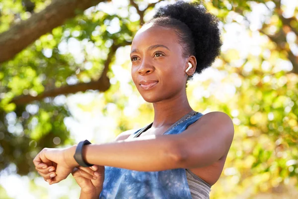 stock image Portrait of young Black woman looking serious, checking fitness watch before run. High quality photo