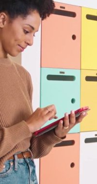 Kampüs kütüphanesinde çok ırklı bir kadın, dijital tablet kullanan bir öğrenci merkezi. Yüksek kaliteli FullHD görüntüler