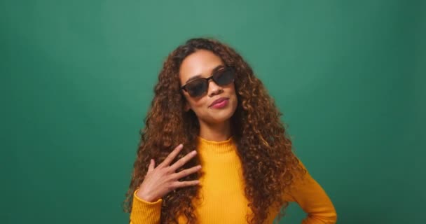 Beautiful Young Woman Cool Attitude Tips Sunglasses Flips Hair Green — Stock Video
