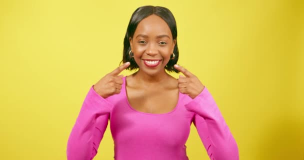 여자는 노란색 스튜디오에서 치아를 가리킨다 고품질 — 비디오