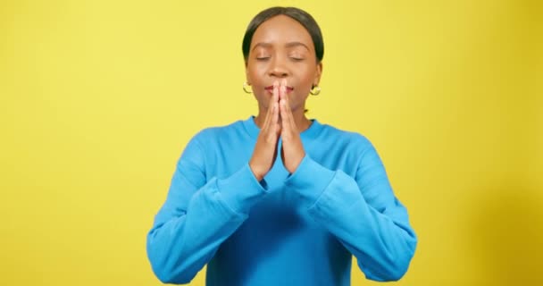 Calm Young Woman Puts Hands Prayer Position Praying Yellow Studio — Stock Video