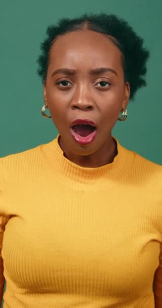 Shocked Confused Young Woman Puts Hands Mouth Green Studio Background — Stock Video