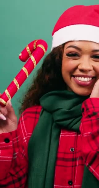 Excited Young Woman Waves Candy Cane Decoration Christmas Hat Studio — Stock Video