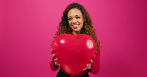 Beautiful Young Woman Throws Heart Shaped Balloon Air Laughing Studio — Stock Video