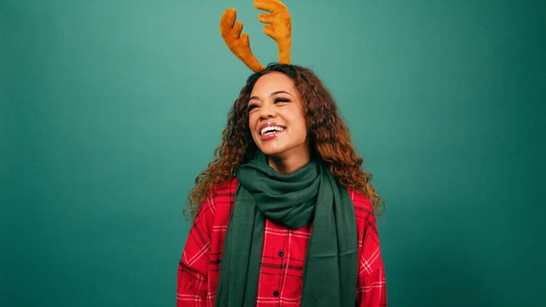 Portrait of a laughing young woman dressed in Christmas colours, studio video. High quality photo