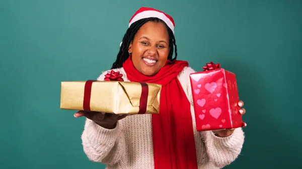 Beautiful young Black woman hands over wrapped Christmas gift. High quality photo