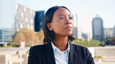 Portrait of a confident businesswoman in a professional suit standing outdoors in an urban setting with modern buildings in the background. clipart