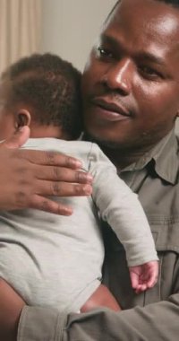 Sevgi dolu bir baba, yeni doğmuş bebeğini nazikçe kucağına alarak, sevgi ve bağlılık dolu bir sahne yaratıyor. Yumuşak ışıklandırma ve samimi ortam ebeveyn ve çocuk arasındaki bağı vurgular, erken ebeveynliğin değerli bir anını yakalar..