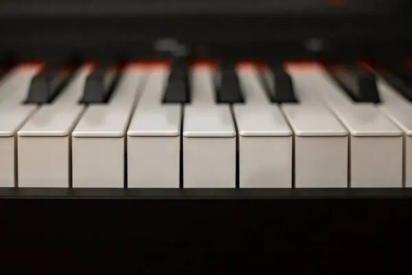 stock image Keyboard synthesizer on a dark background. Electric piano close-up. Electronic musical keyboard synthesizer close-up. Music education concept. High quality photo