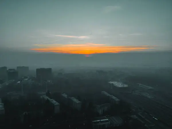 Foggy sunrise with Milan skyline from a drone