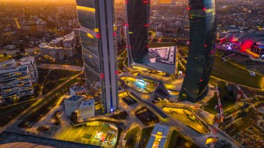 Milan, Lombardy, İtalya 01.2024: İş dünyası CityLife Milan 'ın insansız hava aracı görüntüsü. İtalya 'nın finans bölgesinin gökdelenleri ve şehir merkezinin günbatımında Milano manzarası. İş bölgesi. 