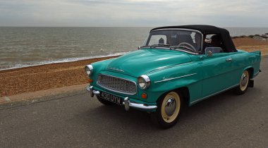 FELIXSTOWE, SUFFOLK, ENGLAND - MAY 01, 2022:  Classic  Skoda Felicia Convertible being driven on  seafront promenade beach and sea in the background.
