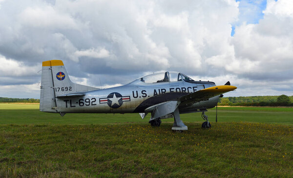 LITTLE GRANSDEN, CAMBRIDGESHIRE,  ENGLAND - AUGUST 27, 2023: Vintage North American T-28 Trojan aircraft on airstrip