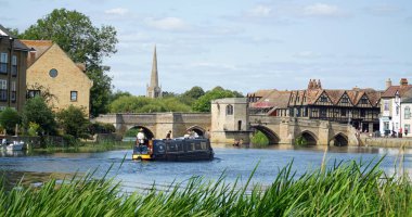 ST IVES, CAMBRIDGESHIRE, ENGLAND - AUGUST  17, 2024: Bridge over the river Ouse at St Ives Cambridgeshire with narrow boat clipart