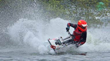 WYBOSTON, BEDFORDSHIRE, ENGLAND - MAY 024, 2024:    Jet Ski racer cornering at speed creating at lot of spray clipart