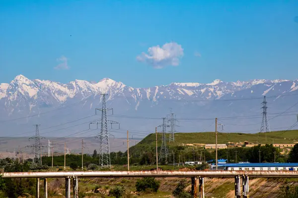 Dağları ve mavi gökyüzü olan güzel bir manzara.