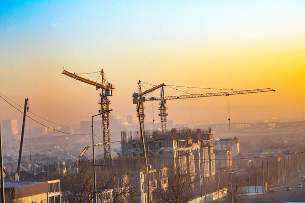 Construction cranes and building under the sky