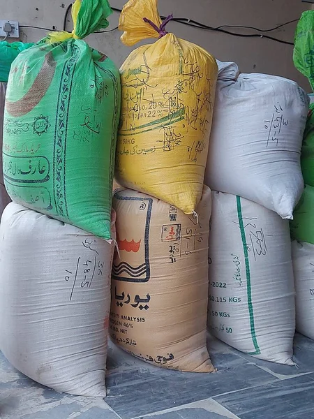 A stack of bags of flour sold in Pakistan market. A powder form flour after crushing wheat. Packed it into bags for sale in a market.Can be used as commercia.Royality free.