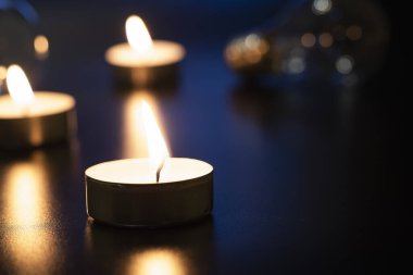 Arka planda yanan bir çok mumun alevi