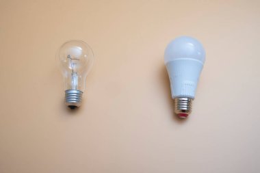 Electric light bulbs. energy efficiency concept. LED lamp vs incandescent lamp. Composition on a yellow background. Use economical light bulbs.