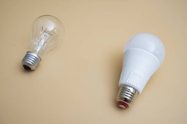 Electric light bulbs. energy efficiency concept. LED lamp vs incandescent lamp. Composition on a yellow background. Use economical light bulbs.