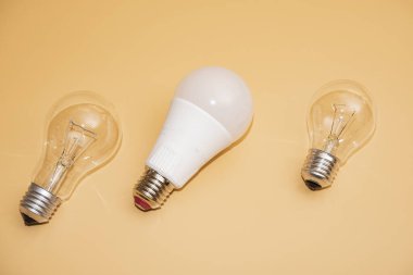 Electric light bulbs. energy efficiency concept. LED lamp vs incandescent lamp. Composition on a yellow background. Use economical light bulbs.