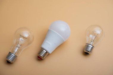 Electric light bulbs. energy efficiency concept. LED lamp vs incandescent lamp. Composition on a yellow background. Use economical light bulbs.