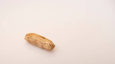 Peanuts in shell isolated on white background. Heap of peanuts close up