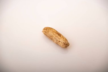 Peanuts in shell isolated on white background. Heap of peanuts close up