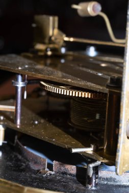 The mechanism of an old watch. clock mechanism made in the technique of toning. Focus on the central gears. Very shallow depth of field