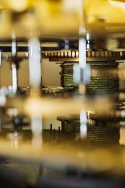 The mechanism of an old watch. clock mechanism made in the technique of toning. Focus on the central gears. Very shallow depth of field