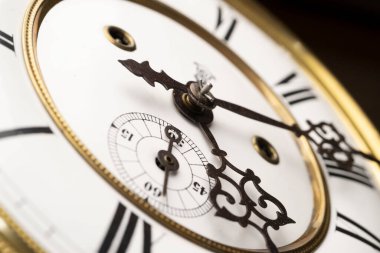 Vintage Clock with Hands. Close up view on clock face of a historical watches with golden frame