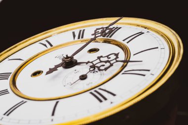 Vintage Clock with Hands. Close up view on clock face of a historical watches with golden frame