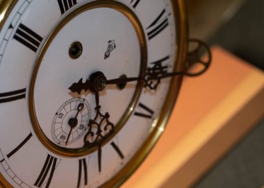 Vintage Clock with Hands. Close up view on clock face of a historical watches with golden frame