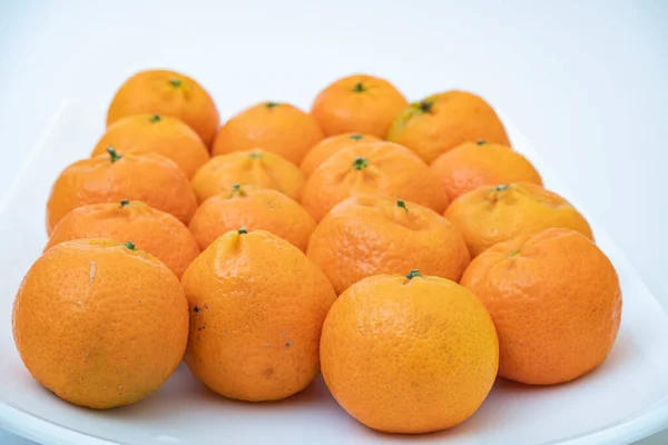 tangerine on a white background.How to choose, store and how much you can eat so as not to harm the body.
