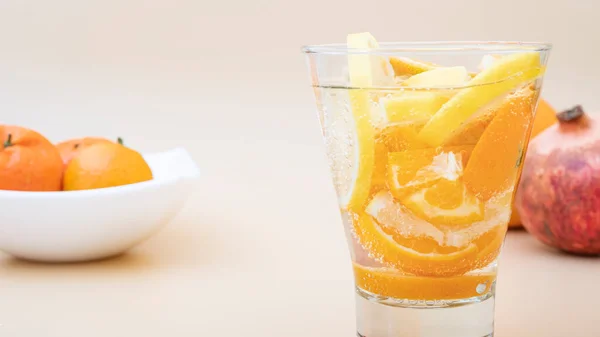 Summer orange cocktails with citrus fruits on an orange background. lemonade, refreshing drinks, low alcohol non-alcoholic cocktails, summer party concept.